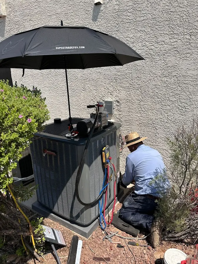 HVAC technician performing outdoor AC maintenance in Ashland City