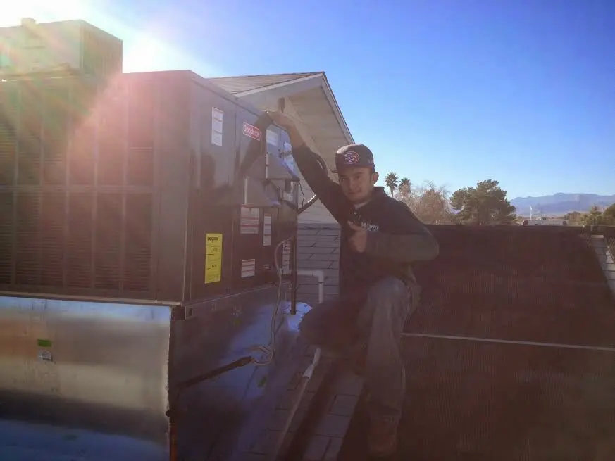 HVAC technician performing HVAC Inspection on a rooftop unit in Ashland City